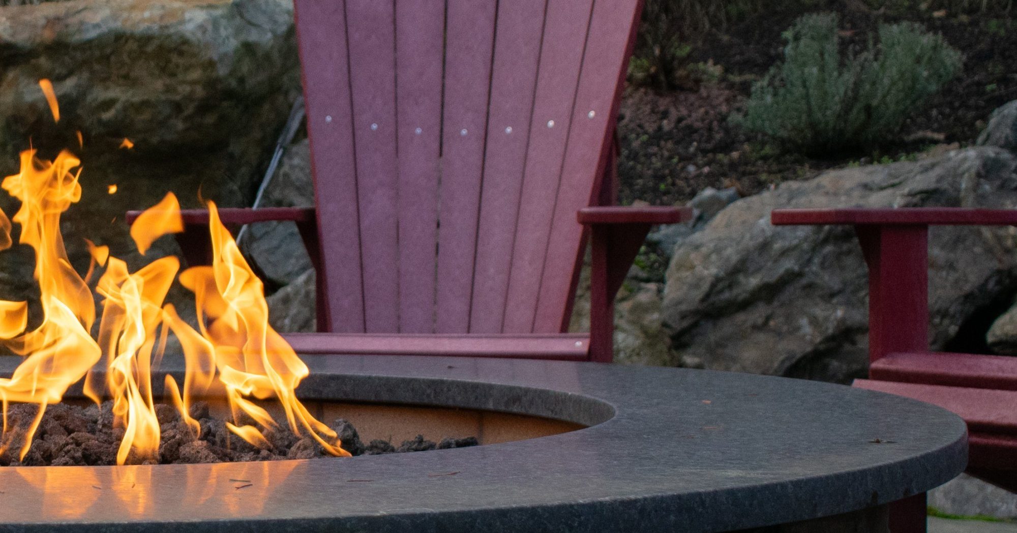 Half a propane fire feature with flames and seating