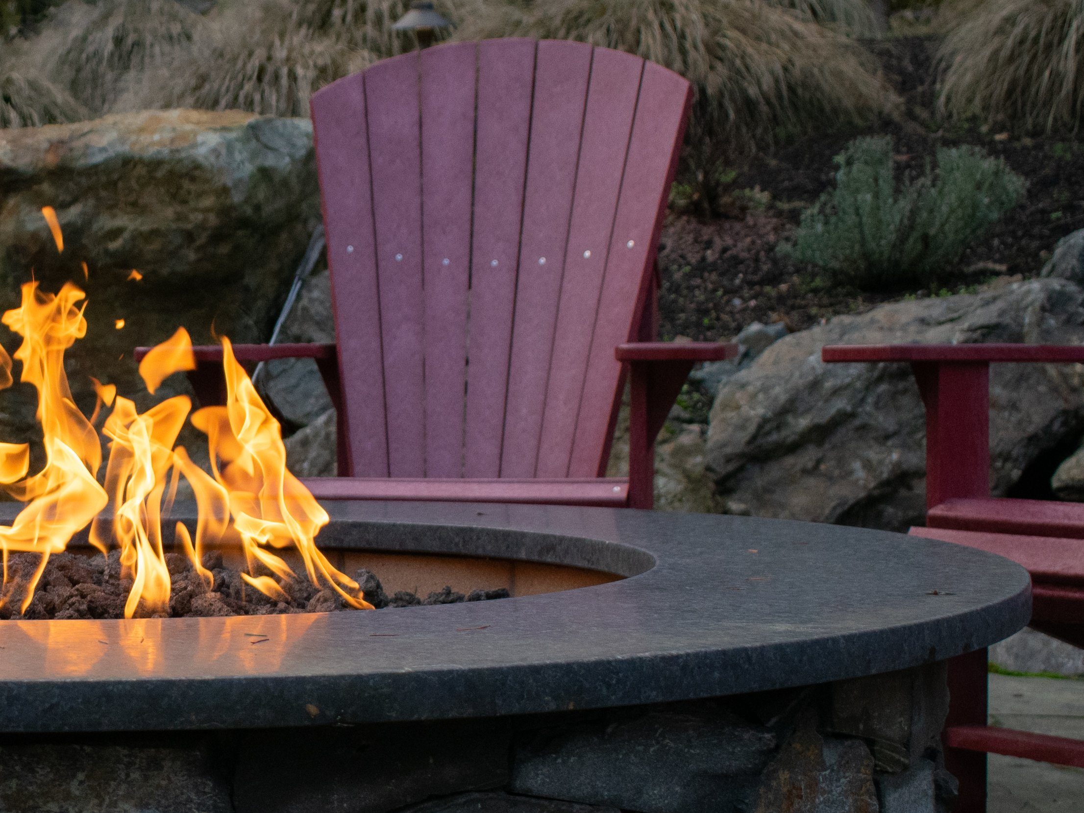 Half a propane fire feature with flames and seating