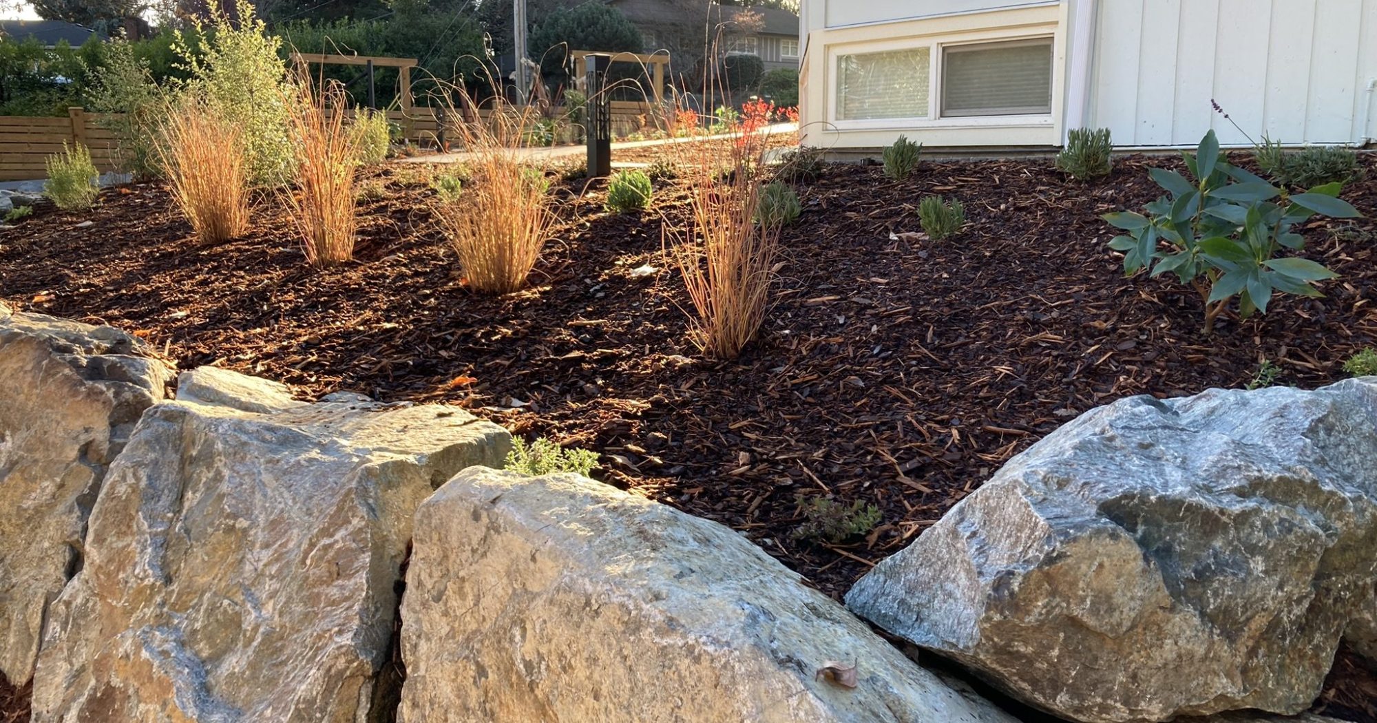 Mulching service Mulching service applied in a tiered garden bed construction in colwood