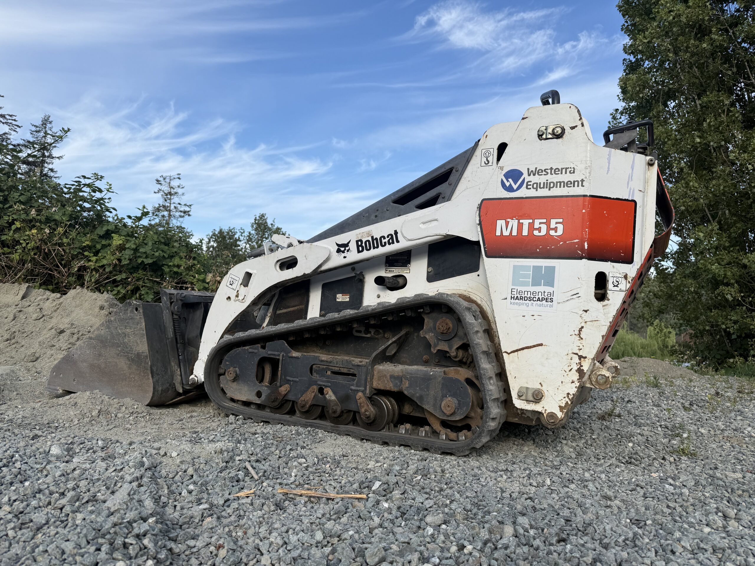 Mini bobcat loader with beautiful blue sky